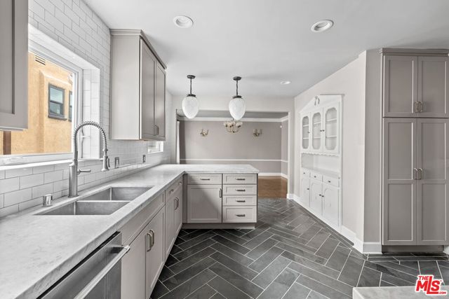 a kitchen with a sink stove and cabinets