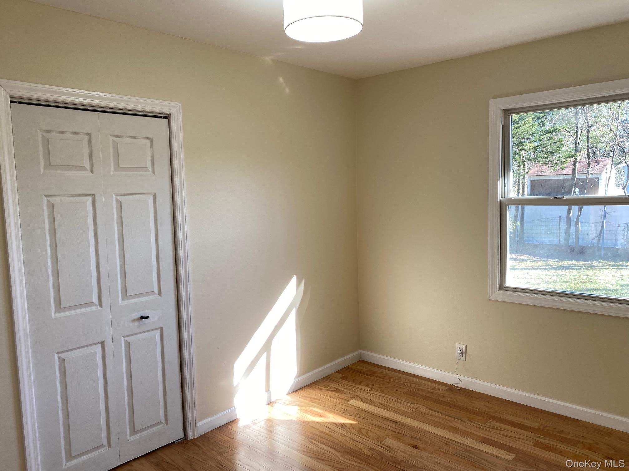 5 Smith Road Cornwall, NY 12518 - Photo 22 of 33 an empty room with wooden floor and windows