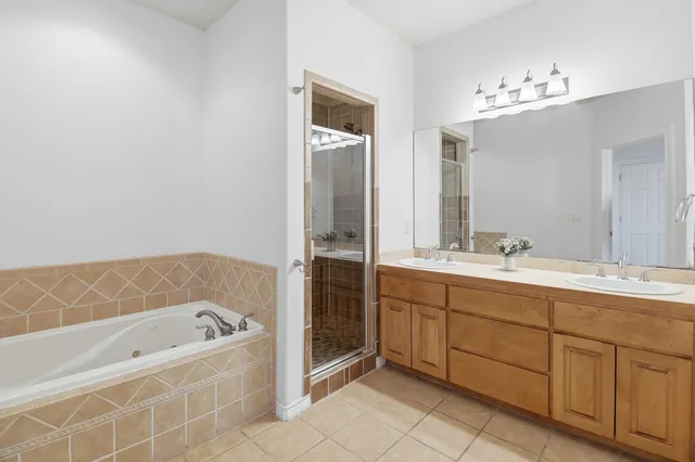 a bathroom with a shower sink and mirror