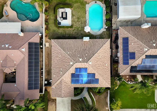 an aerial view of a house with a swimming pool
