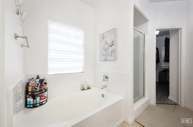 a bathroom with a bathtub and a window