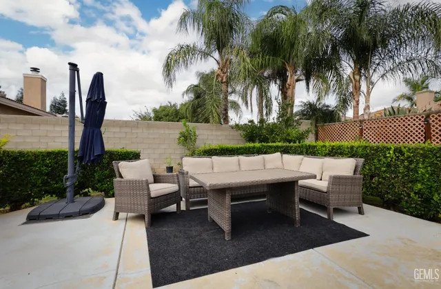 a view of a patio with a table and chairs