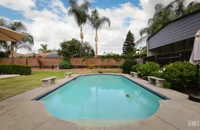 a view of a swimming pool with a yard