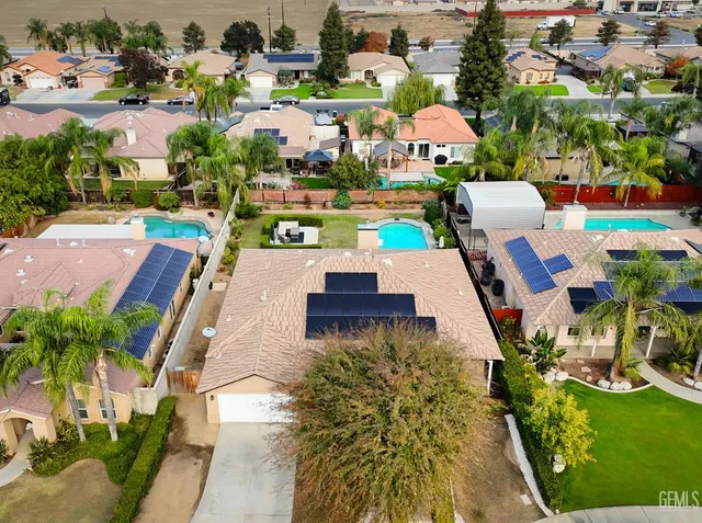 an aerial view of multiple houses with yard