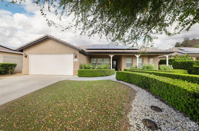 a front view of house with yard and green space