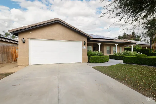 a view of house with outdoor space and parking