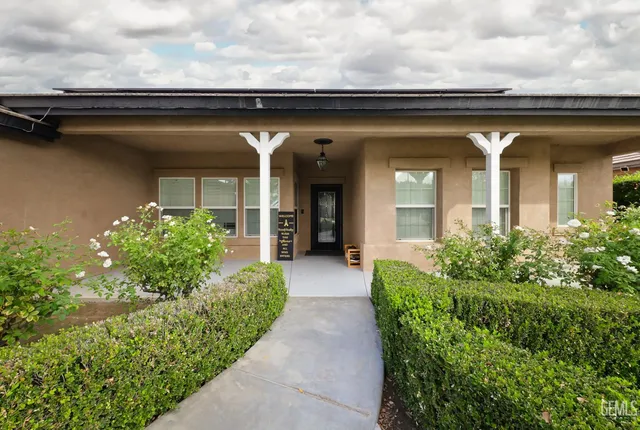 a view of a house with potted plants