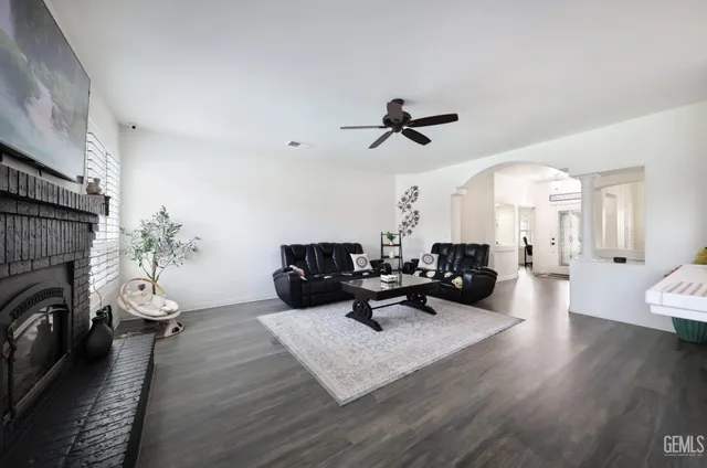 a living room with furniture floor to ceiling window and a fireplace