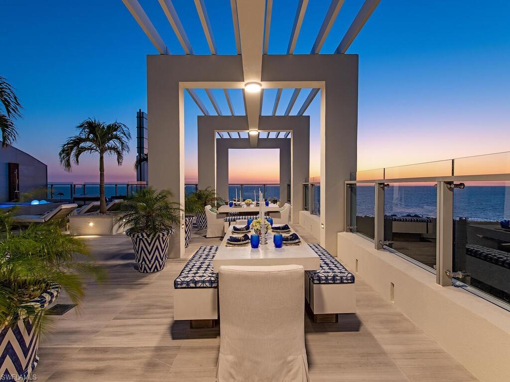 a living room with furniture and a view of kitchen