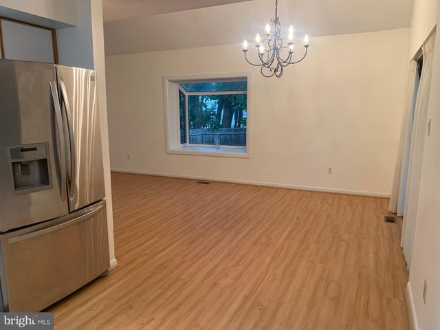 a view of a refrigerator in kitchen and wooden floor