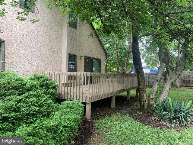 a view of a house with a yard and deck