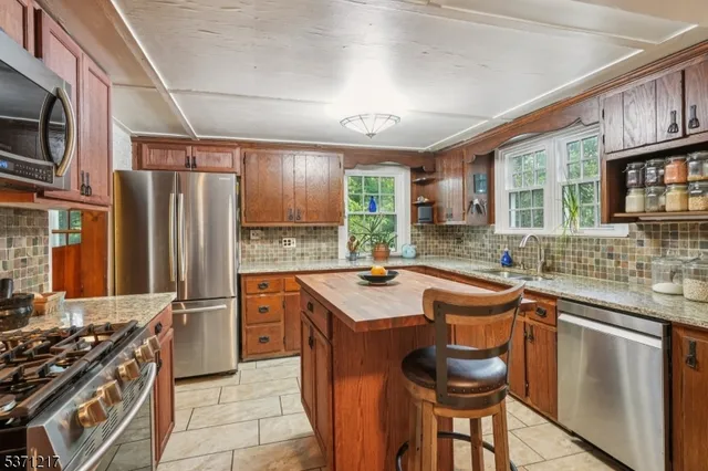 a kitchen with a sink window and cabinets