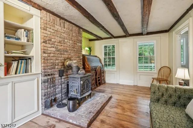 a view of hallway with stairs and wooden floor