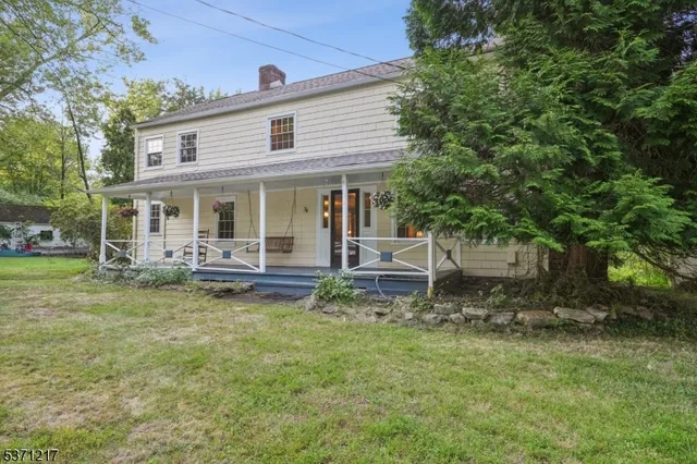 a view of hallway with wooden floor and stairs
