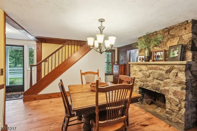 a dining room with furniture a chandelier and wooden floor