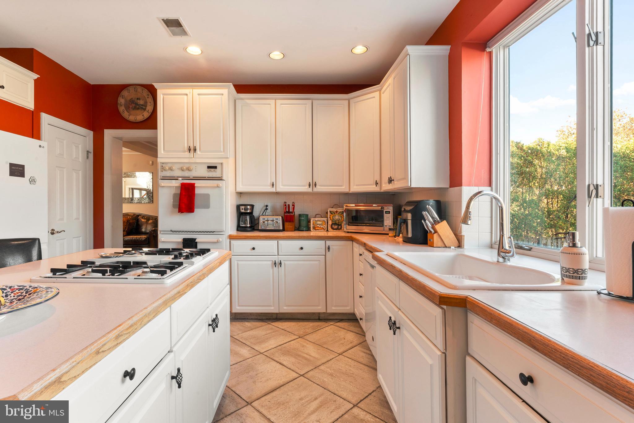 67 Lenape Road Richboro, PA 18954 - Photo 12 of 43 a kitchen with kitchen island granite countertop a sink appliances cabinets and a large window