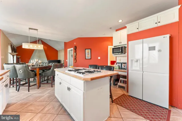 a kitchen with stainless steel appliances granite countertop a stove and refrigerator