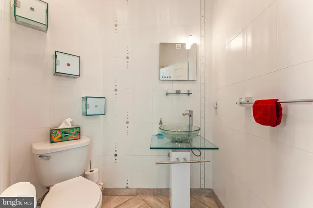 a bathroom with a toilet sink and mirror