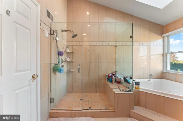 a bathroom with a tub and shower
