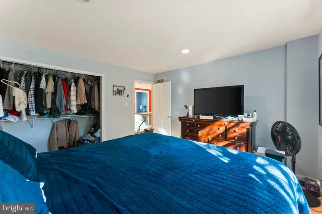 a bedroom with furniture and a flat screen tv
