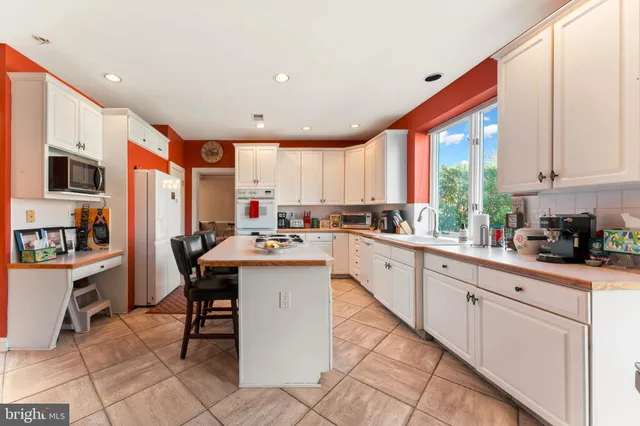 a kitchen with stainless steel appliances kitchen island granite countertop a sink and cabinets