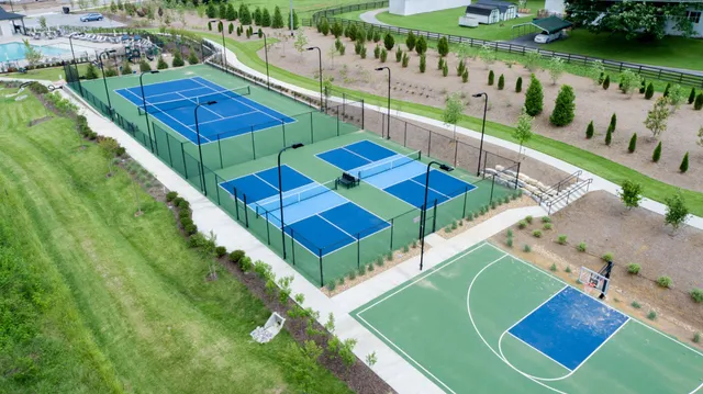 a view of a tennis ground with a swimming pool