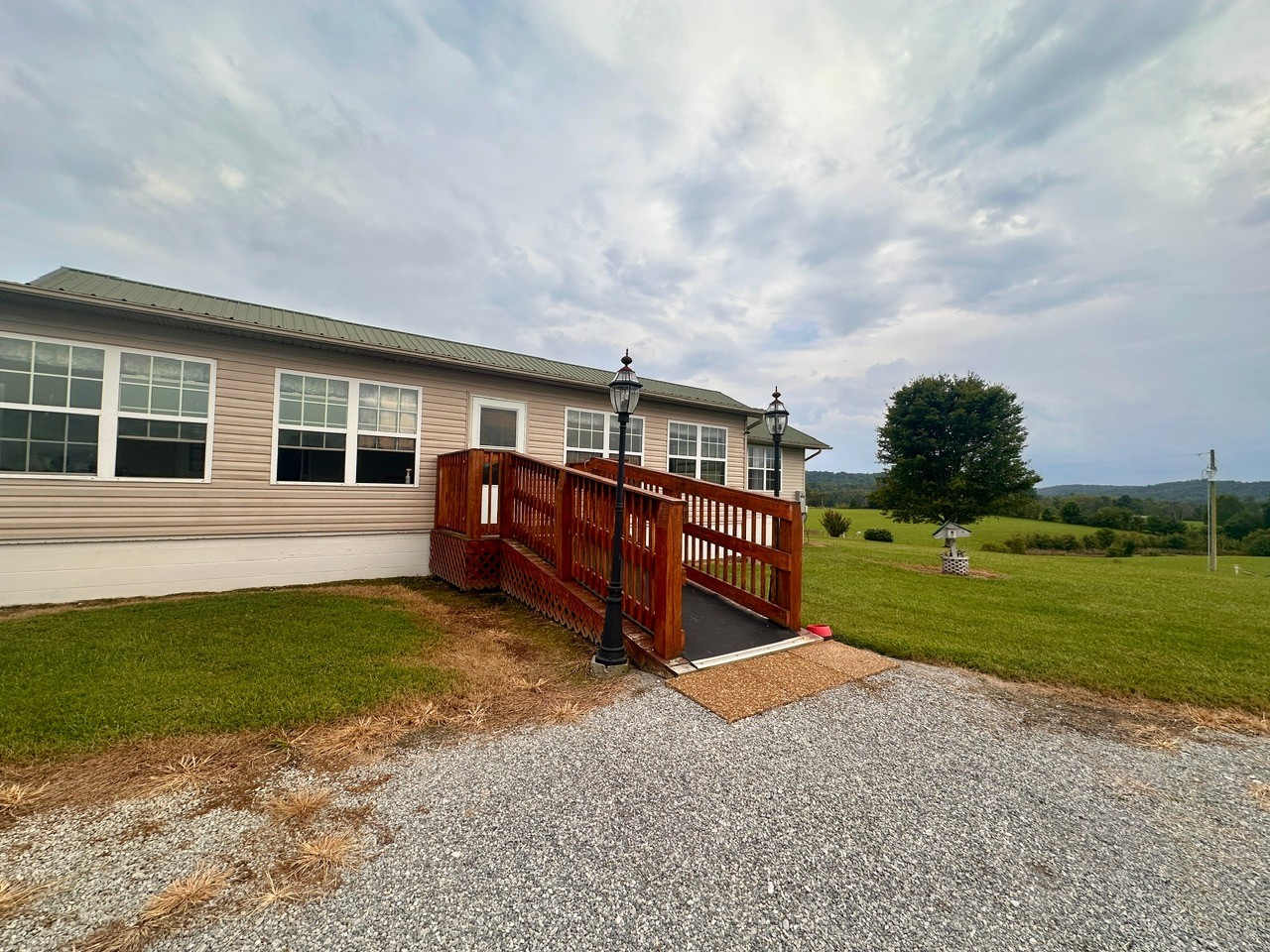 12343 Griffith Road Pikeville, TN 37367 - Photo 20 of 28 a backyard of a house with lots of green space table and sofas