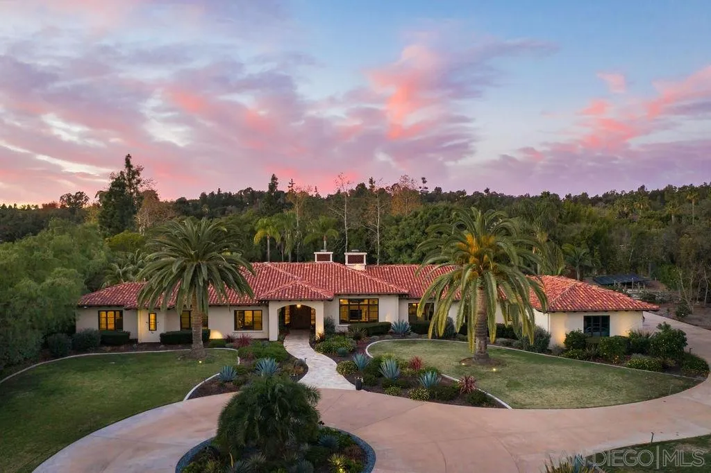 a view of a town with barn house in the background