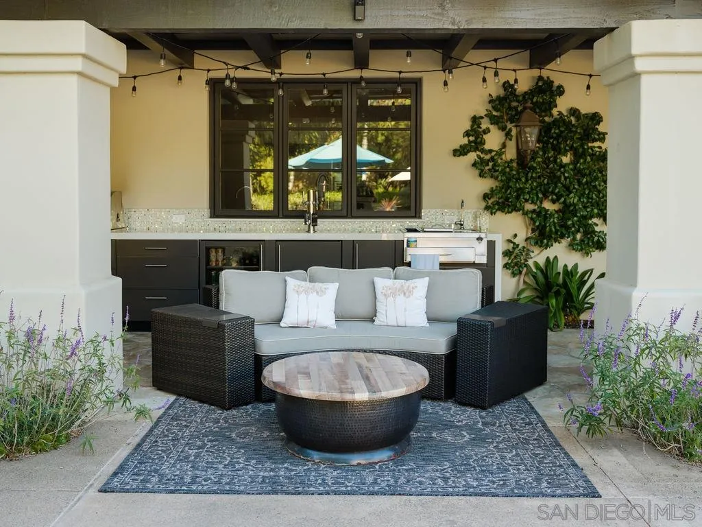18072 Rancho La Cima Corte Rancho Santa Fe, CA 92067 - Photo 17 of 32 a living room with furniture and a potted plant