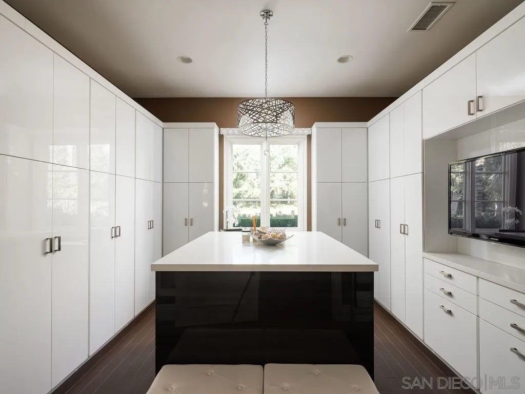 18072 Rancho La Cima Corte Rancho Santa Fe, CA 92067 - Photo 21 of 32 a kitchen with a sink a window and cabinets