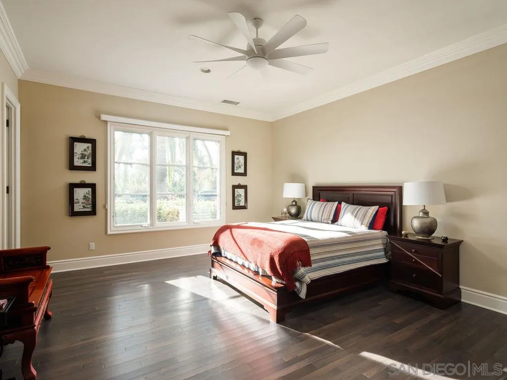 18072 Rancho La Cima Corte Rancho Santa Fe, CA 92067 - Photo 23 of 32 a spacious bedroom with a bed and a large window