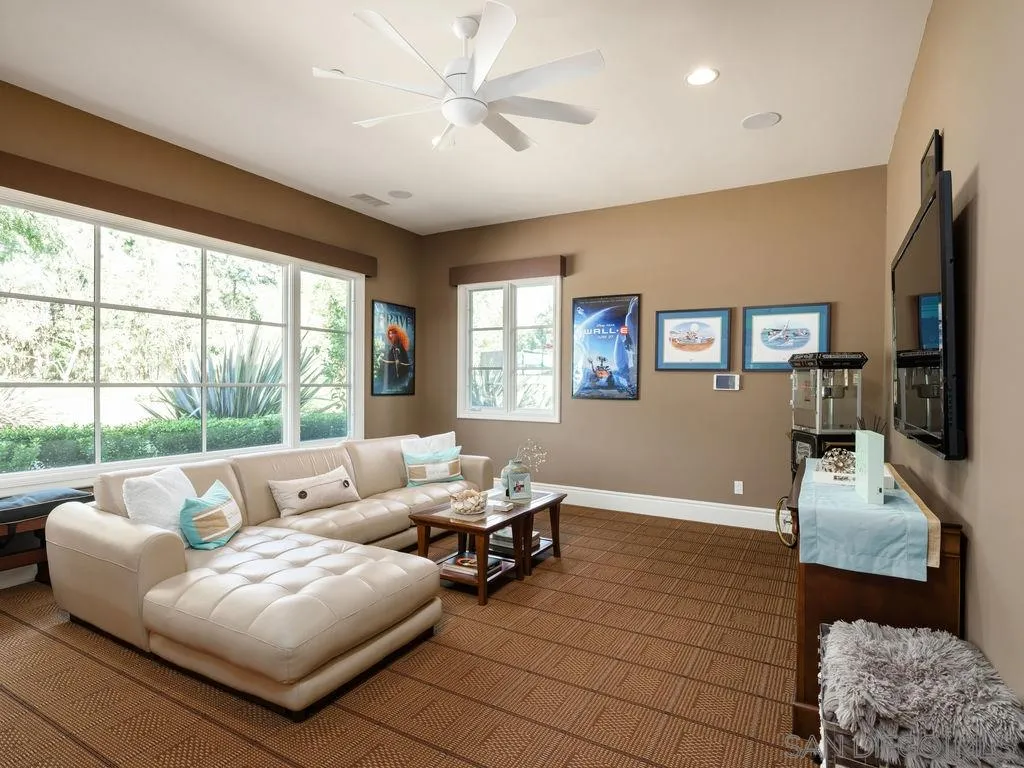 18072 Rancho La Cima Corte Rancho Santa Fe, CA 92067 - Photo 25 of 32 a living room with furniture and a flat screen tv