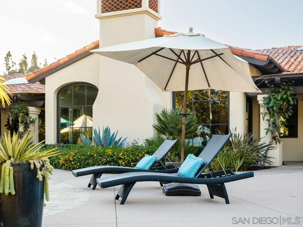 18072 Rancho La Cima Corte Rancho Santa Fe, CA 92067 - Photo 27 of 32 a view of backyard with wheel chair potted plants and large tree