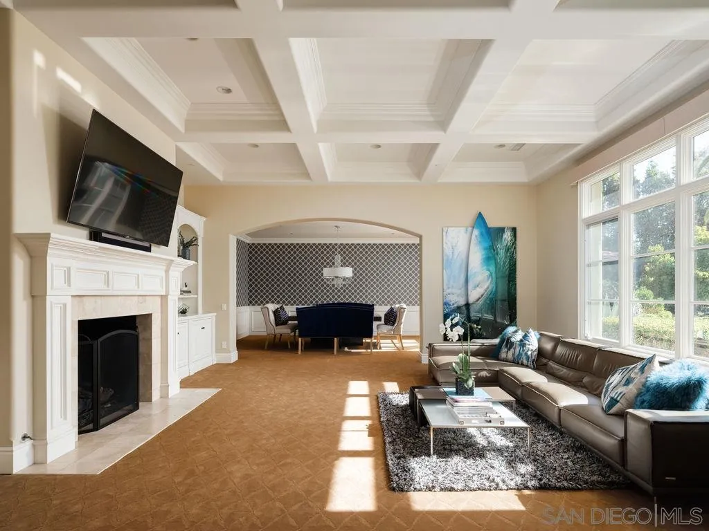 18072 Rancho La Cima Corte Rancho Santa Fe, CA 92067 - Photo 7 of 32 a living room with furniture a fireplace and a flat screen tv