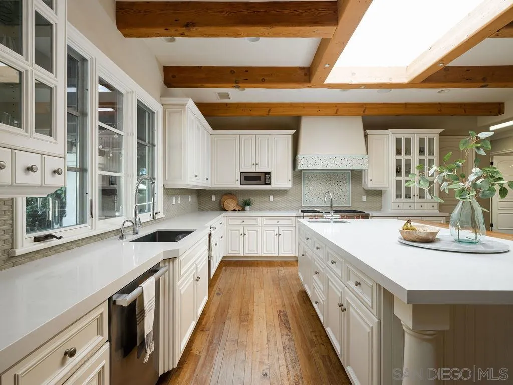 18072 Rancho La Cima Corte Rancho Santa Fe, CA 92067 - Photo 10 of 32 a kitchen with a sink stove and cabinets