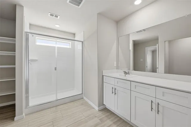 a bathroom with a double vanity sink and mirror