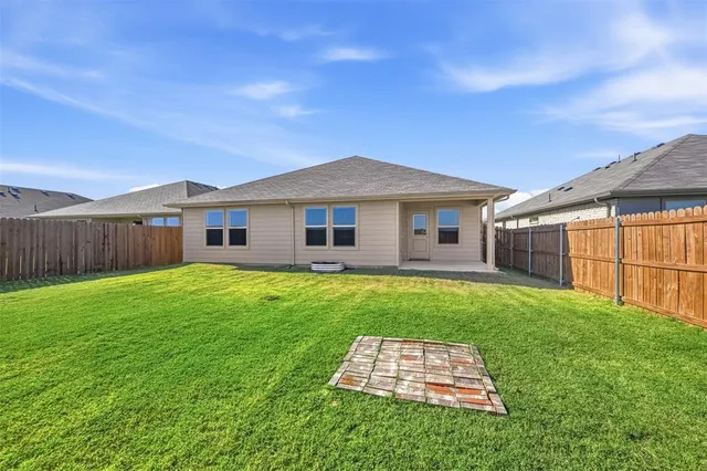 a picture of a bench in front of a white house