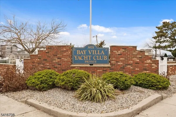 a view of a chair and table in the backyard