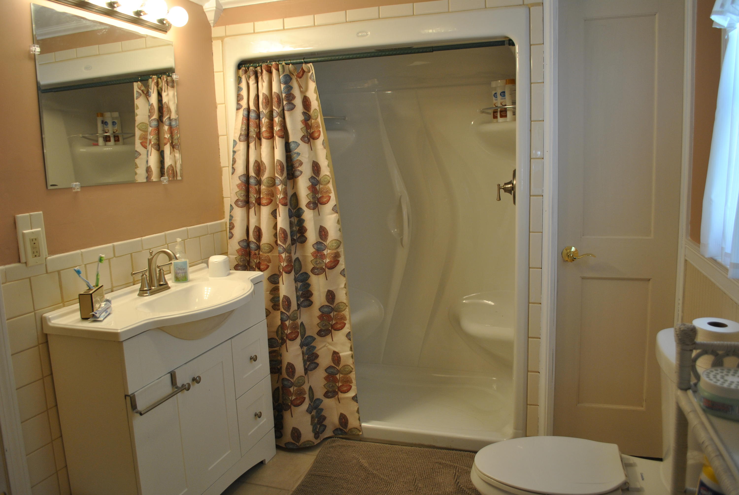 83 Lake Drive Centerville, MA 02632 - Photo 15 of 35 a bathroom with a sink toilet and shower