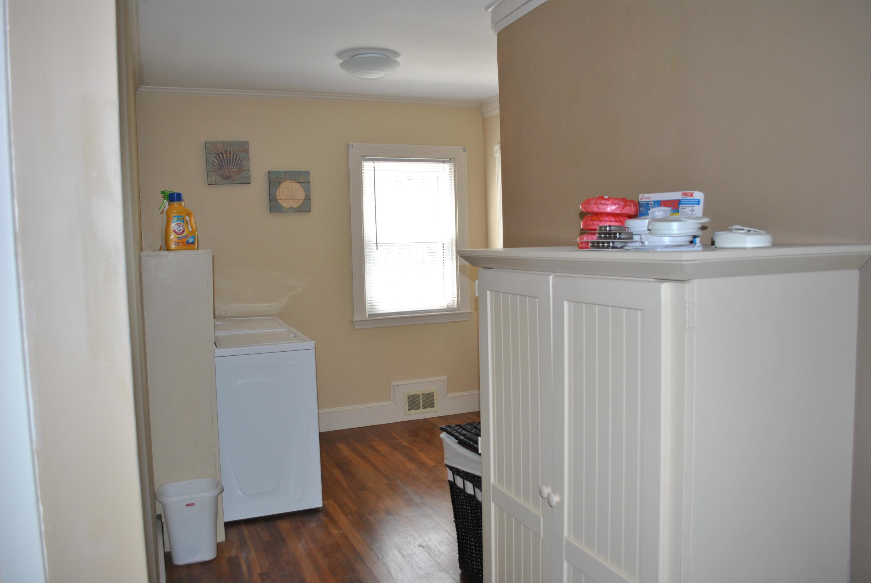 83 Lake Drive Centerville, MA 02632 - Photo 17 of 35 a storage room with wooden floor washer and dryer