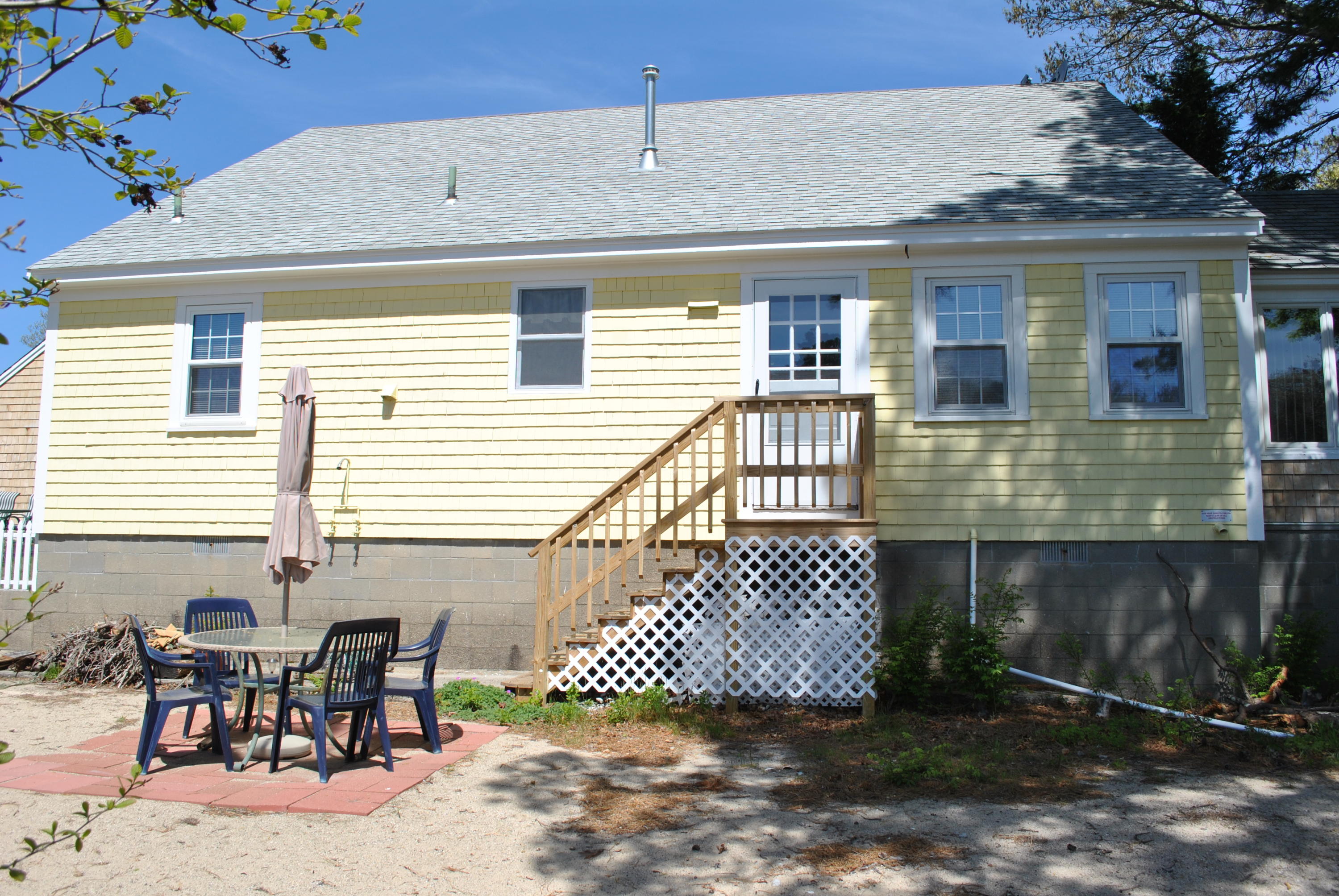 83 Lake Drive Centerville, MA 02632 - Photo 28 of 35 a front view of a house with a bench