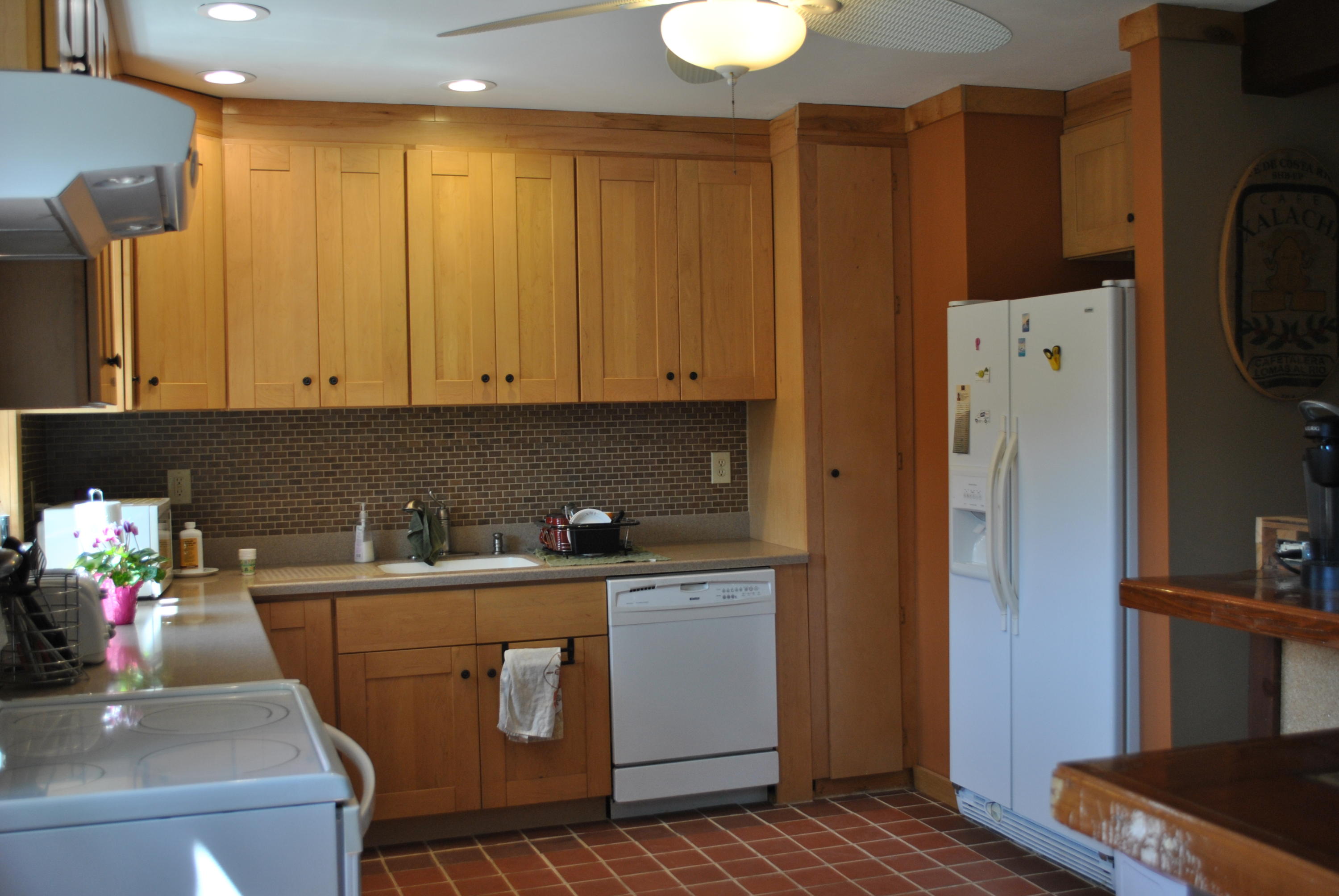 83 Lake Drive Centerville, MA 02632 - Photo 4 of 35 a room with stainless steel appliances white cabinets and wooden floors