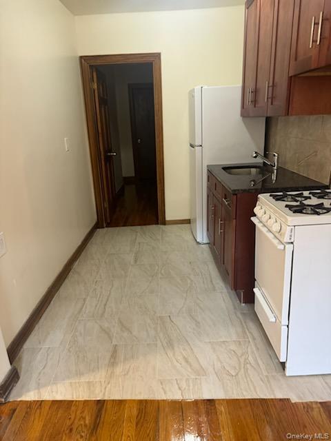 3191 Fulton Street Brooklyn, NY 11208 - Photo 1 of 8 a kitchen with a stove and a refrigerator