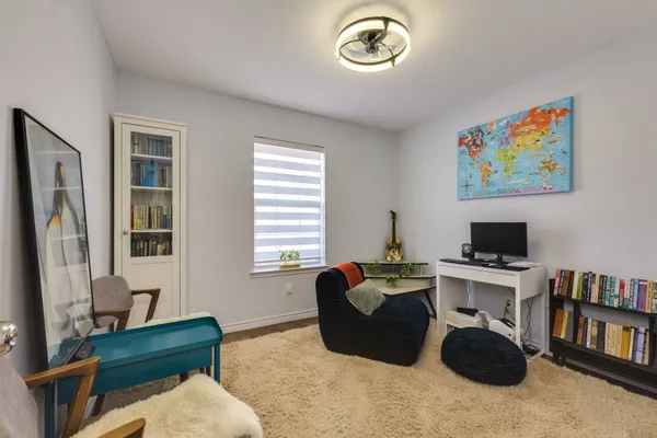 a large bed sitting in a bedroom next to a window