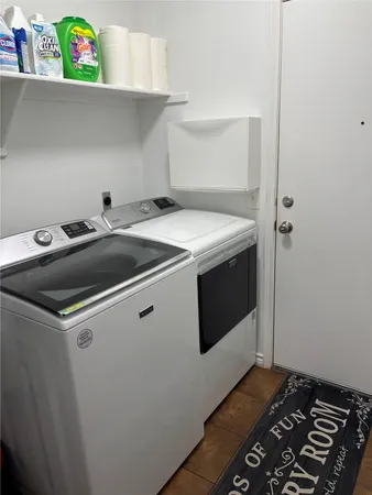 a large brick house with a big yard and large trees