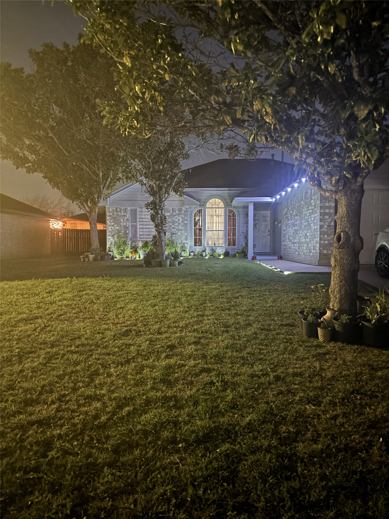 507 Clear Spring Lane Leander, TX 78641 - Photo 21 of 25 a large brick house with a big yard and large trees