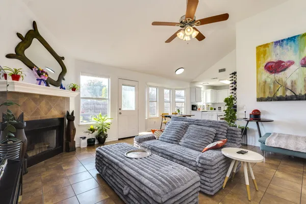 a living room with furniture a flat screen tv and a fireplace