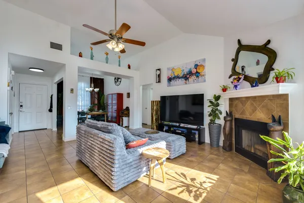 a dining room with furniture potted plants and wooden floor