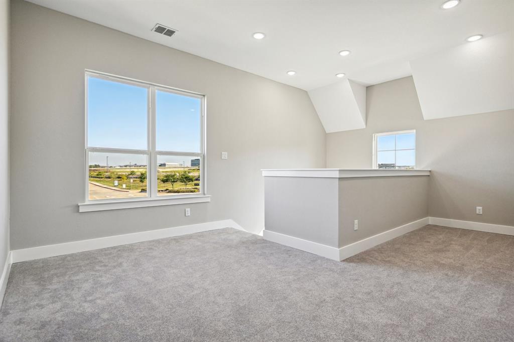1711 Paytyn Drive Allen, TX 75013 - Photo 17 of 37 Spare room with lofted ceiling, a healthy amount of sunlight, and light colored carpet