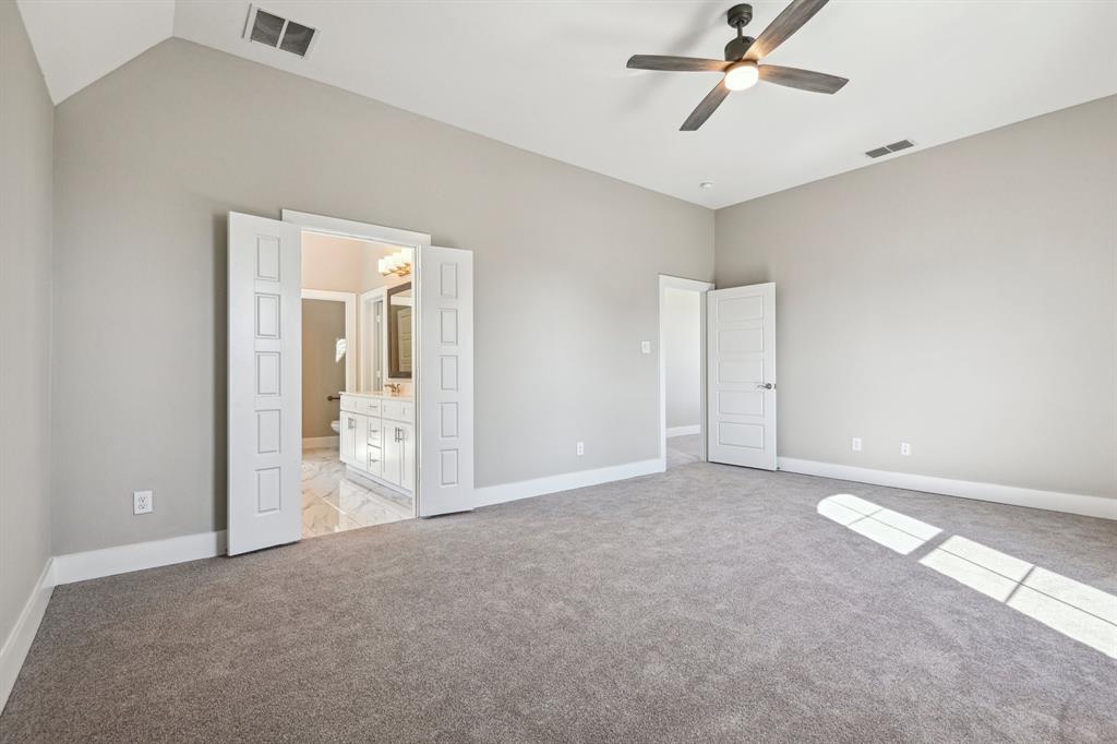 1711 Paytyn Drive Allen, TX 75013 - Photo 19 of 37 Unfurnished bedroom featuring light carpet, lofted ceiling, ceiling fan, and ensuite bathroom